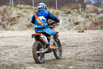 man riding a motocross in a protective suit