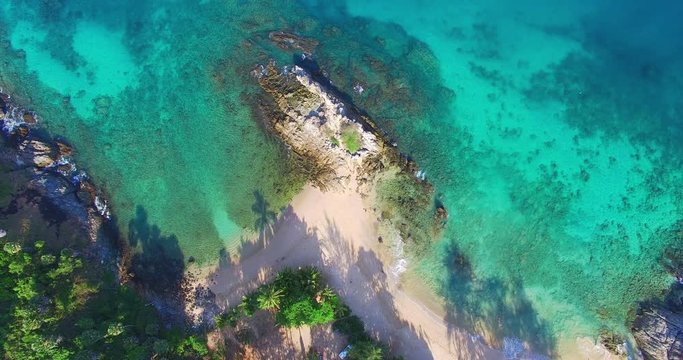 aerial view above blue sea. Nui beach small beach in the middle of Promthep cape and wind turbine in front of beach is Dorn island. Nui beach is the good place for swimming snorkeling and sea canoe
