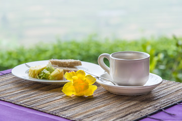Close-up of black tea in white cup on the background of desert
