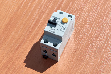 On the table there is an automatic switch of differential current. The device protects human life from electric shock. It combines an automatic switch plus a protective shutdown device.