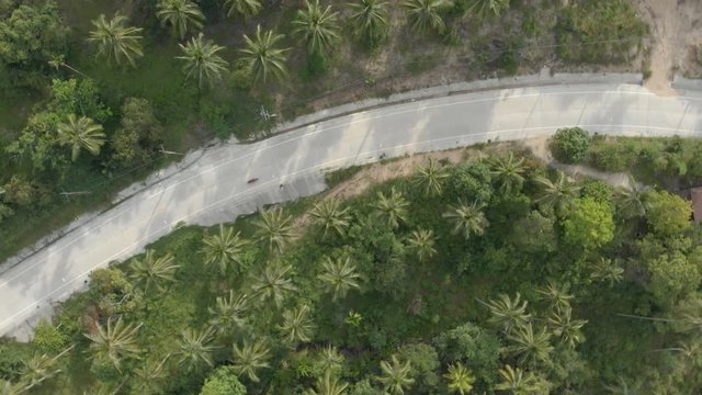5 flat aerial shots in cinelike-D. Biker riding motorcycle by the road