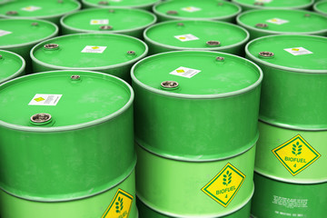 Group of rows of green stacked biofuel drums in storage warehouse - obrazy, fototapety, plakaty