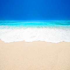 Beautiful Tropical  beach with Soft wave of blue ocean, white sand and  sky. Summer travel holiday background concept. Sea panorama with copyspace.