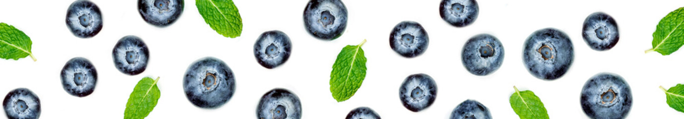 Creative pattern made of blueberries with  leaves. Fresh berry fruits isolated on white background. Flat lay. Food concept..