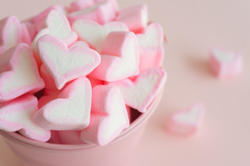 Fluffy pink heart marshmallow in small tank on pink background