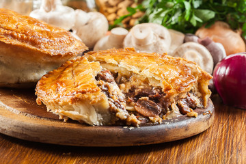 Fresh beef stew pie on a cutting board