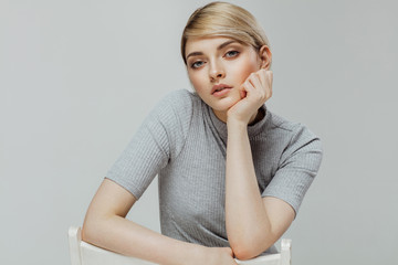 Portrait of of fashion model with natural skin isolated on grey