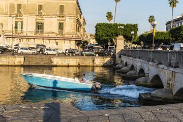 Man sailing in a boat next in Siracusa, Sicily, Italy