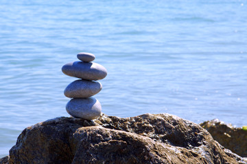 Spa stones balance on beach.