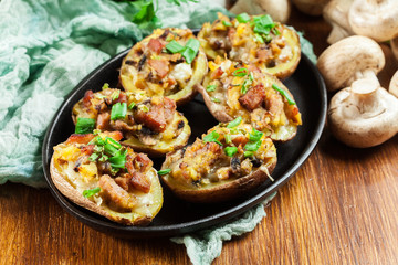 Baked potatoes in jacket stuffed with bacon, mushrooms and cheese. Dish served in baking dish..Baked potatoes stuffed with bacon, mushrooms and cheese