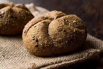 Freshly Baked Whole Wheat Grain Kaiser Roll Round Breads with Sack.