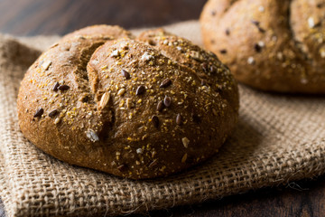 Freshly Baked Whole Wheat Grain Kaiser Roll Round Breads with Sack.