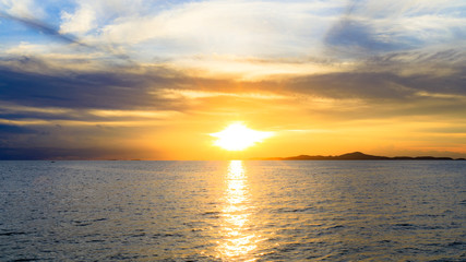 Fototapeta premium Sunset over island sea or ocean at the evening time with blue sky.