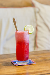 Frozen strawberry margarita cocktail in margarita glass