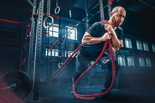 Men With Battle Rope Battle Ropes Exercise In The Fitness Gym. CrossFit.