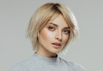 Obraz premium Beauty portrait of female face with natural skin isolated on grey