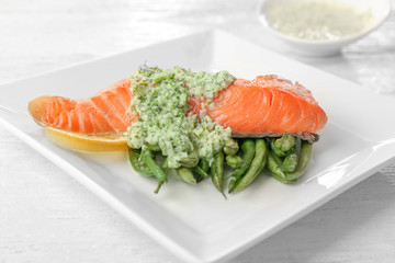Plate with tasty fish and green beans, closeup
