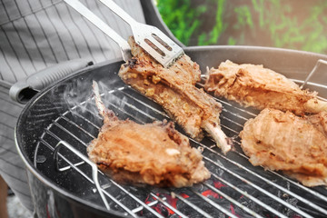 Cooking of appetizing juicy spare ribs outdoors