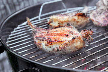 Cooking of appetizing juicy spare ribs outdoors