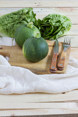 Green zucchini balls. Wooden table and board. 