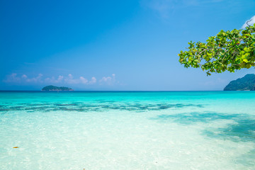 Fototapeta na wymiar Crystal clear water of tropical island beautiful beach in sunny day - Summer breeze travel holiday