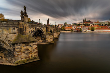 Famous iconic image of Charles bridge at sunset in spring, Prague, Czech Republic. Concept of world travel, sightseeing and tourism.