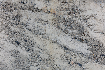 texture of gray concrete close-up. interspersed with colored elements
