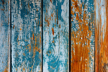 the texture of wooden boards with old cracked paint. orange wood, blue-blue paint, vertical row