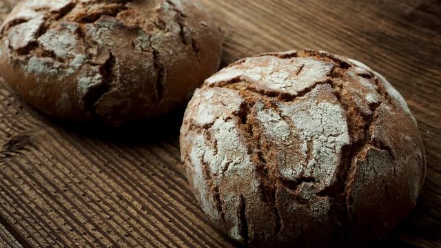Delicious baked bread on a wooden background