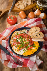 Homemade breakfast fried egg with tomato.