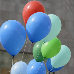 Multicolored balloons filled with gas helium tend to fly up.