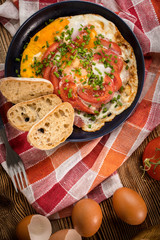 Homemade breakfast fried egg with tomato.