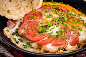 Homemade breakfast fried egg with tomato.