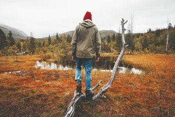 Man wanderer standing alone in swamp forest travel lifestyle concept adventure vacations...