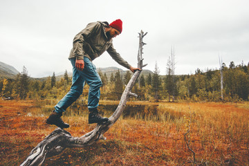 Man traveler survival in wild scandinavian forest active lifestyle adventure vacations swamp nature