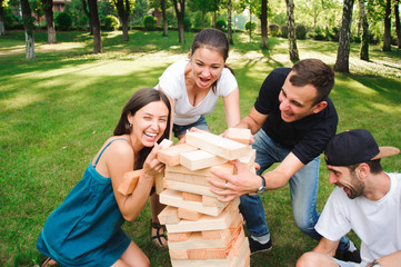 Friends playing board game outdoors.