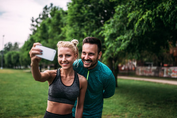 Obraz premium Two athlete making selfie at the park.