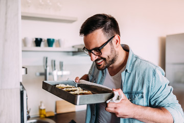 Close-up image of handsome smiling man baking.