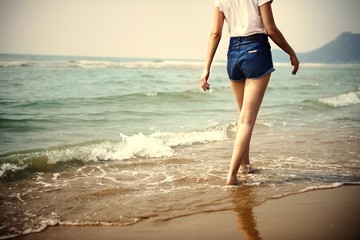 Woman walking by the shore