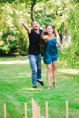 Fototapeta premium Friends plaing outdoor games - ring toss.
