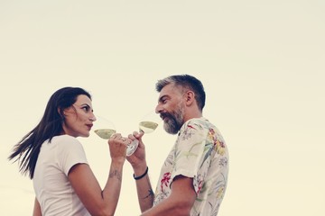Couple enjoying a glass of wine by the beach