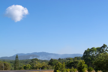 Fototapeta na wymiar Smoke and cloud over rain forest in Tropical North Queensland in Australia