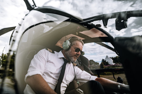 Pilot inside helicopter cockpit