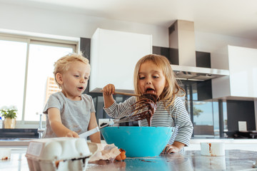 Small kids preparing cake batter