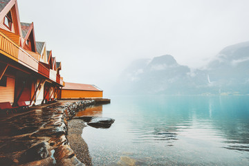 Wooden country houses terrace exterior foggy mountains and sea fjord view in Norway scandinavian style © EVERST