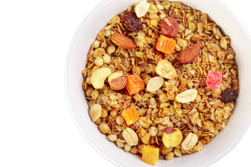 Bowl of homemade granola with fruit pieces isolated on white