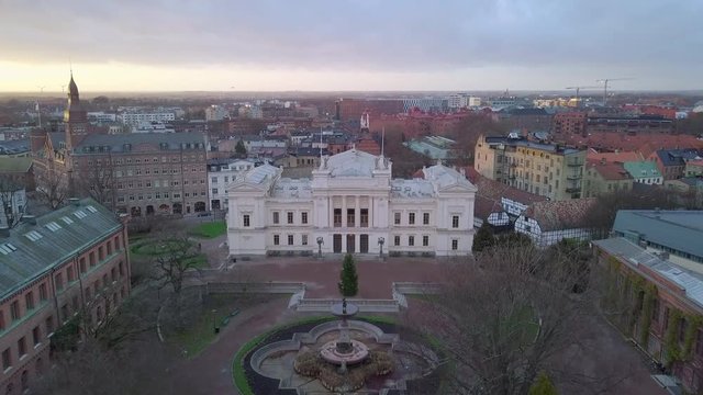 Aerial view of Lund University school building. Establishing drone shot flying towards the main building in Lund city, Sweden