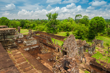 Fototapeta na wymiar A beautiful view of the landscape and ruins on the northern side of Cambodia's Pre Rup temple, taken from the summit of the central sanctuary.