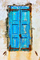 Old window with closed shutters