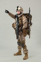 Soldier in camouflage holding rifle